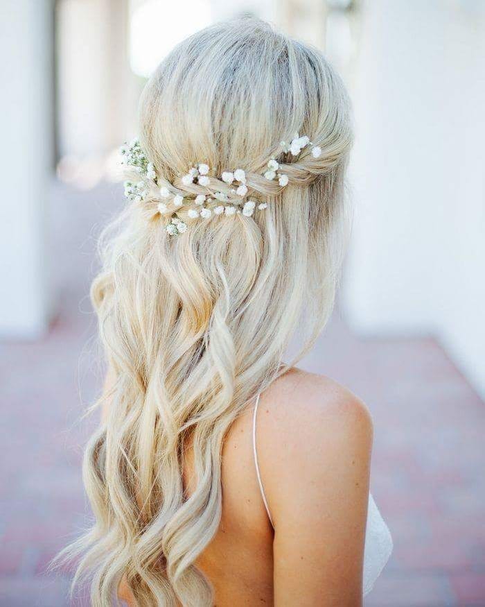 40. Flower-Adorned Loose Curls weddingsmakeupandhair.jpg