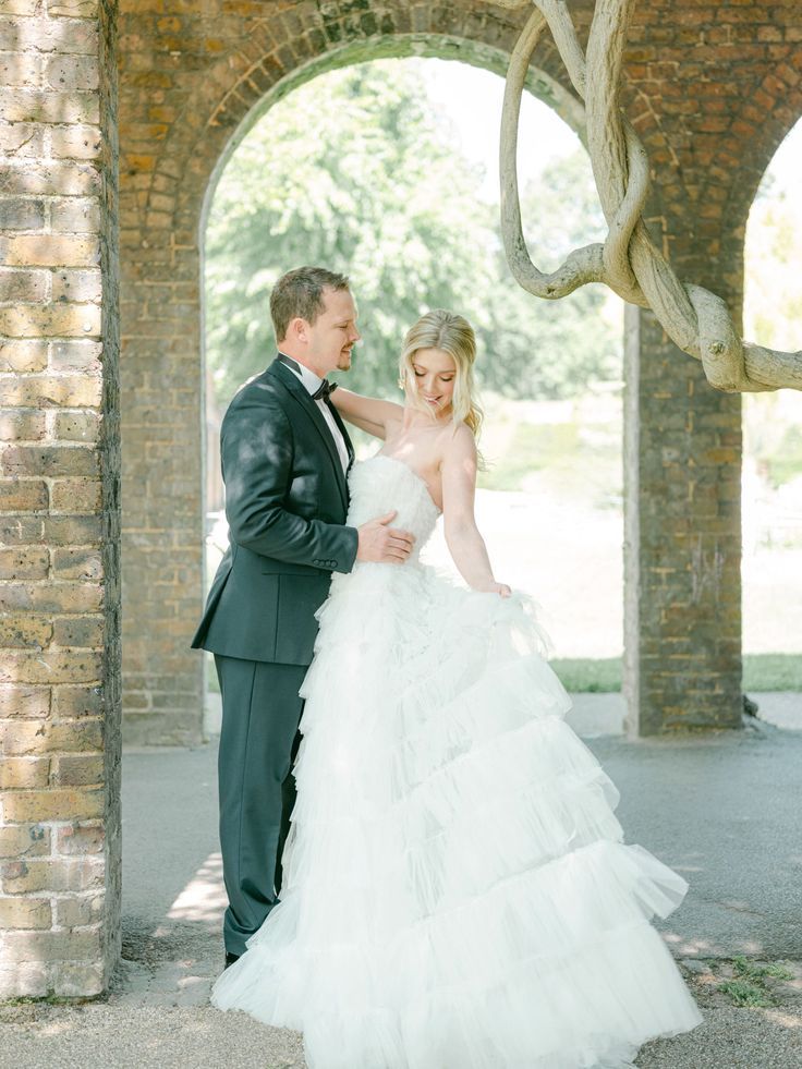 13_Bride and groom garden shoot at the Orangery, Holland Park London Emma Beaumont wedding dress (1).jpg