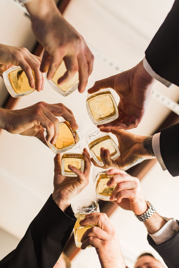 4_Groomsmen Cheers with Whiskey at Midwest Ranch Wedding.jpg